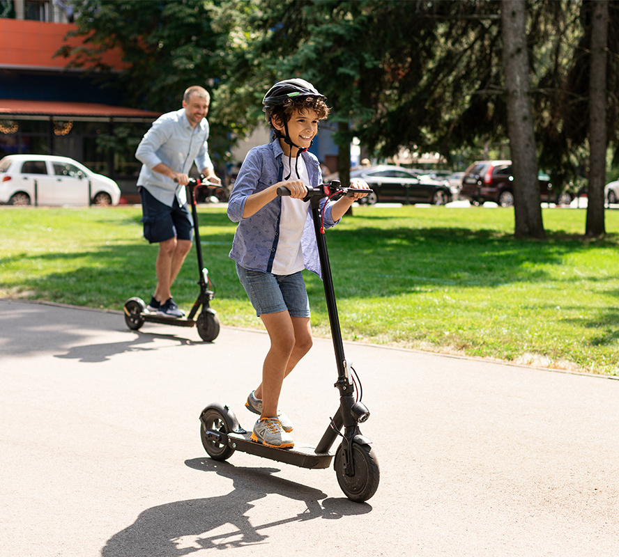 dad and child on e-scooter